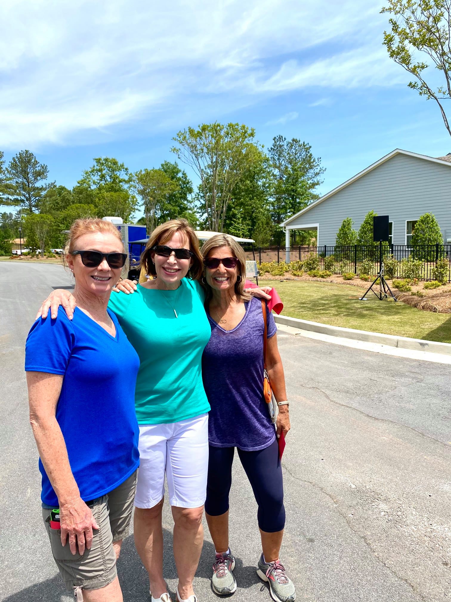 Cresswind Georgia residents posing and smiling at Hoschton Day in front of the model home park